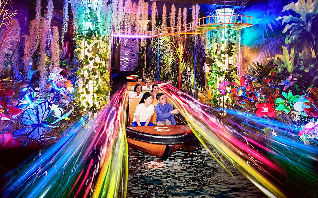 Boat ride through vibrant lights and foliage at Madame Tussauds Singapore.