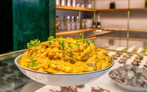 Bowl of curry with herbs at Flora Danica Paris brunch on the Champs Elysées.