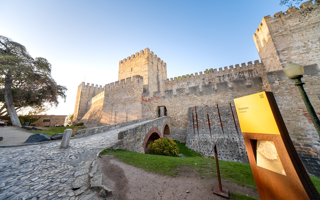 St George's Castle in Lisbon with stone walls and entrance bridge.