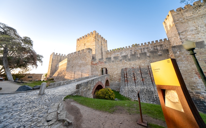 St George's Castle in Lisbon with stone walls and entrance bridge.