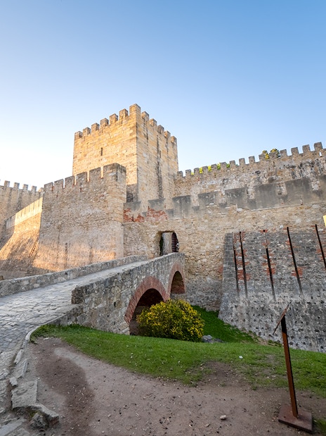 St George's Castle in Lisbon with stone walls and entrance bridge.