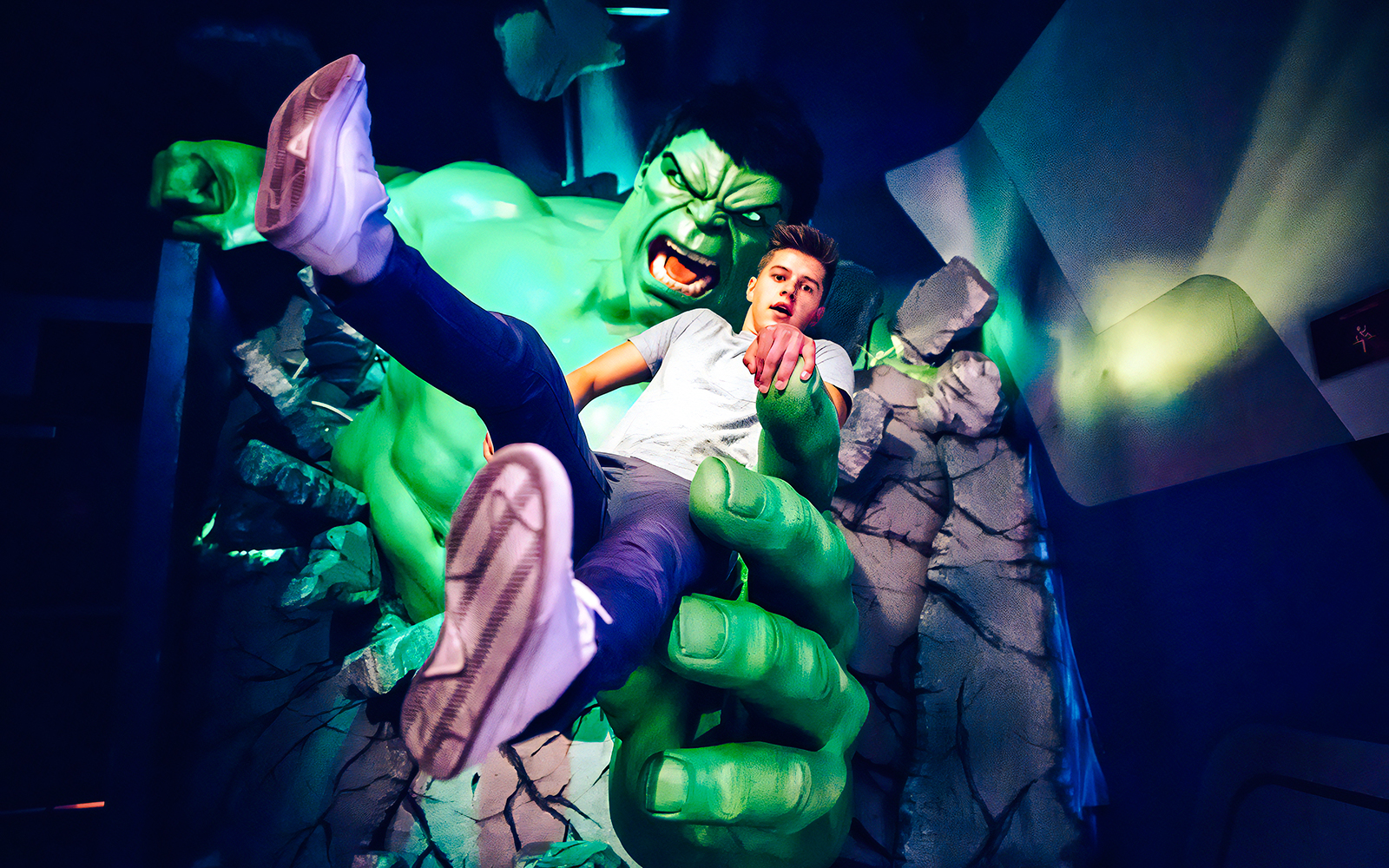 Man posing with Hulk figure at Madame Tussauds.