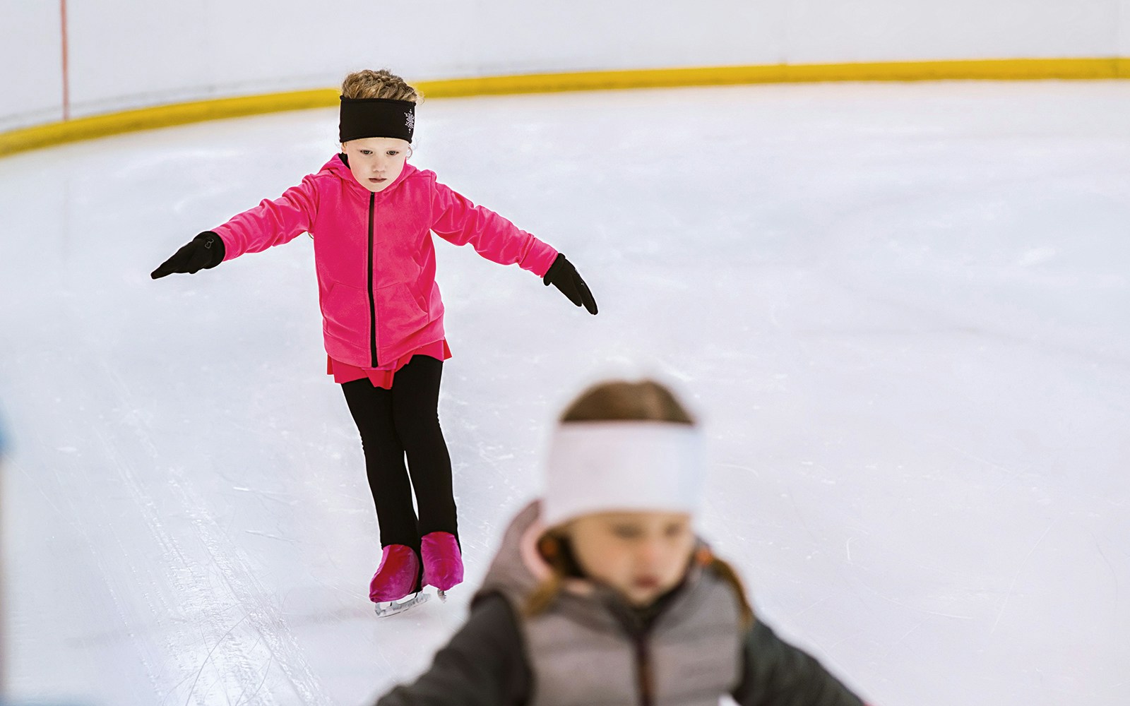 Little girl ice skating in paris during christmas