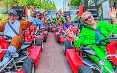 Group enjoying go-kart ride in Shibuya, Tokyo, wearing colorful costumes.