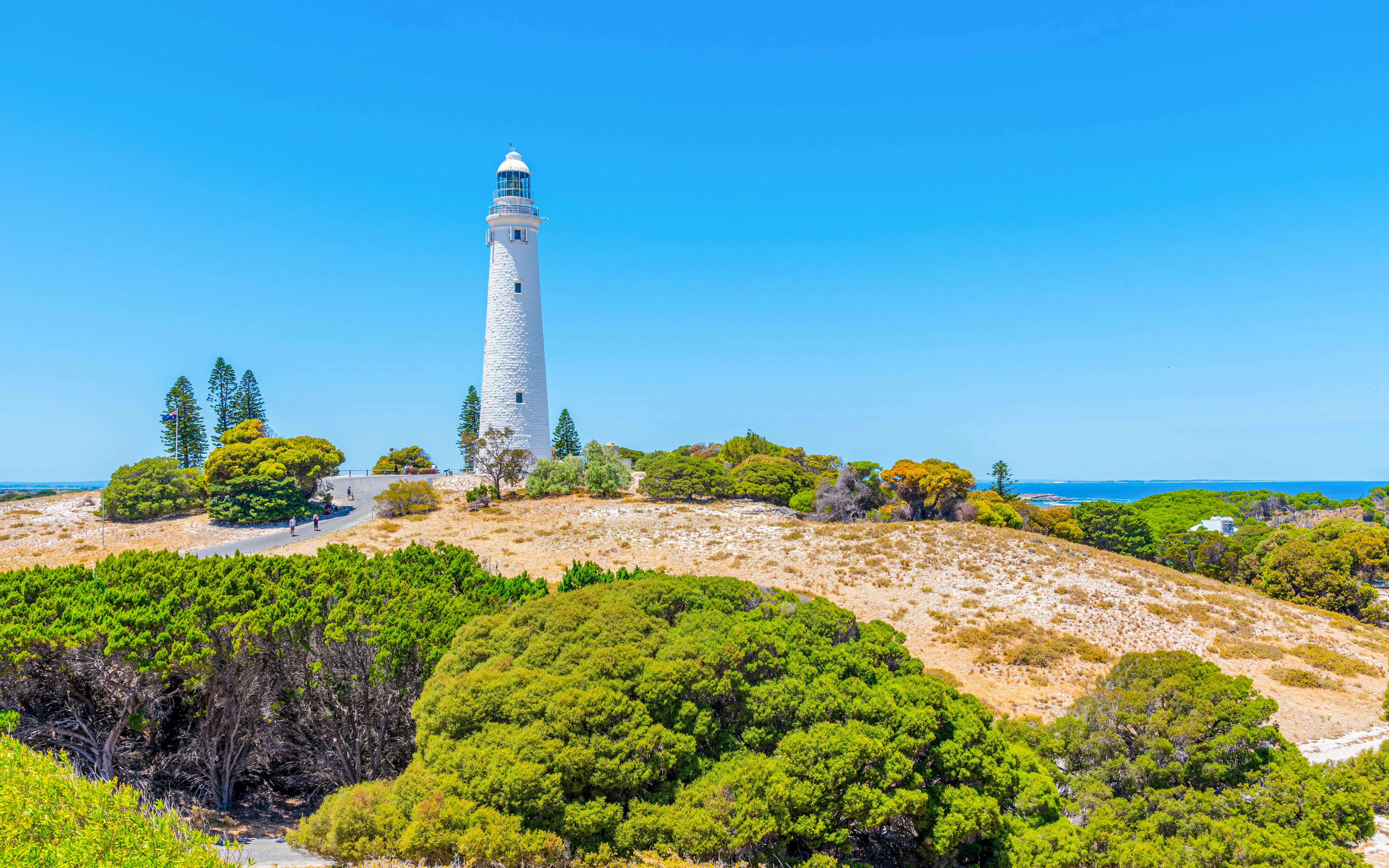 Wadjemup Lighthouse surrounded by greenery on Rottnest Island, Australia.