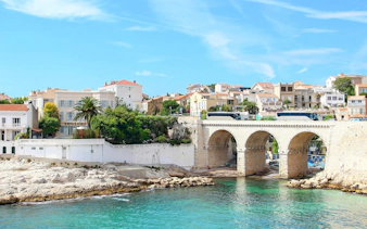 Vallon des Auffes in Marseille with stone bridge and waterfront houses.