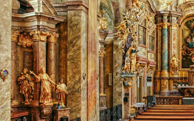 Ornate interior of St Anne's Church with gilded statues and detailed columns.