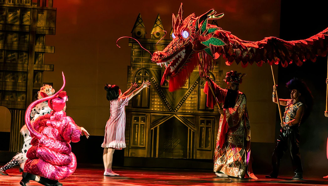 Performance of The Dragon Child with dragon puppet on stage in Sydney.