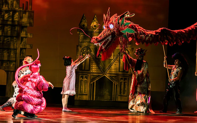Performance of The Dragon Child with dragon puppet on stage in Sydney.