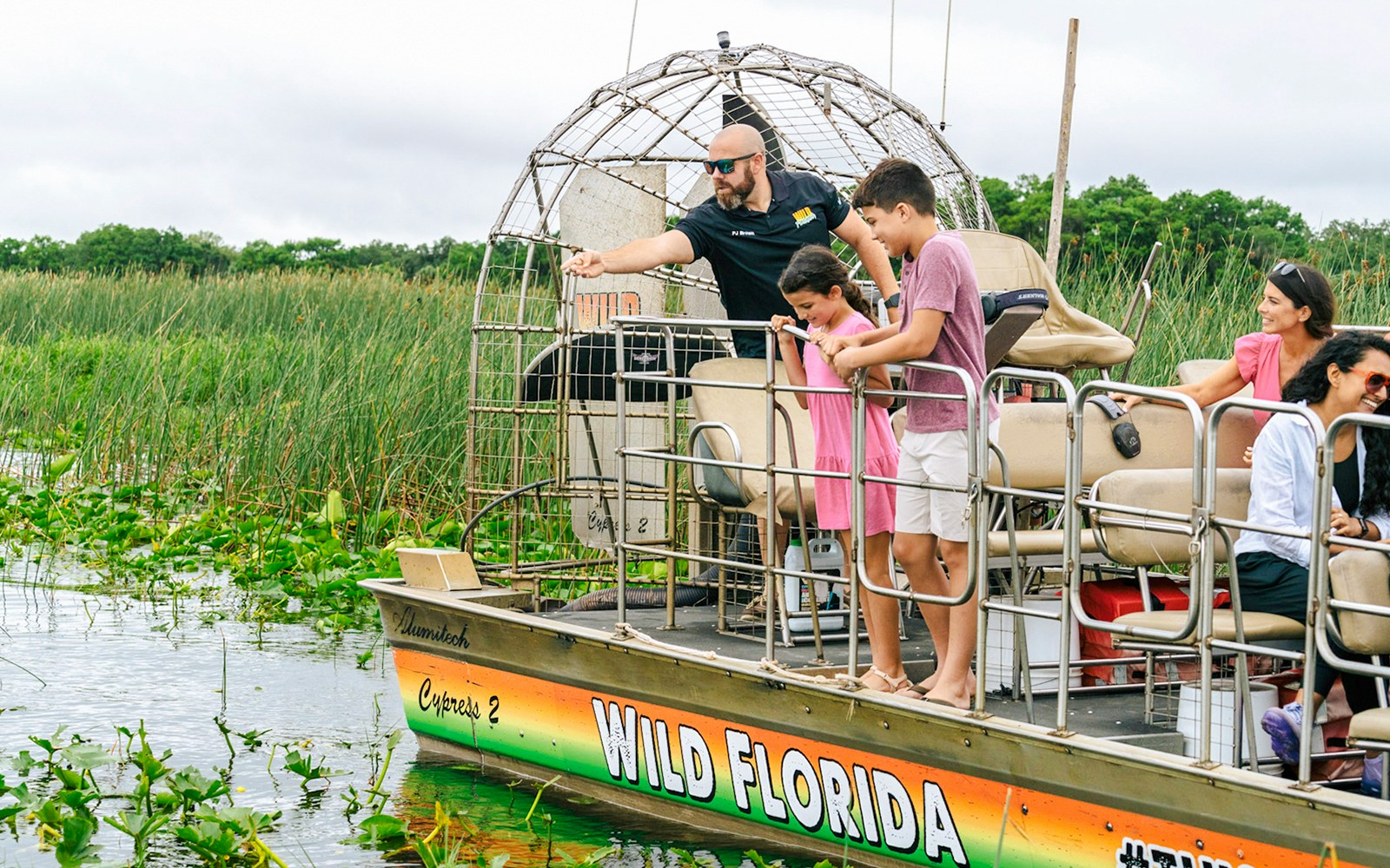 Guests on an airboat tour enjoying the Everglades view in Florida.