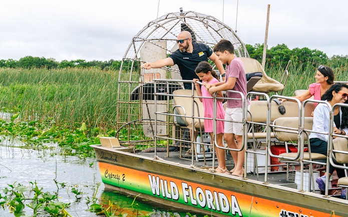 Guests on an airboat tour enjoying the Everglades view in Florida.