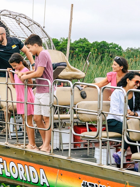 Guests on an airboat tour enjoying the Everglades view in Florida.