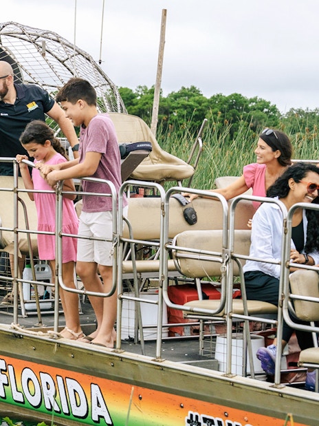 Guests on an airboat tour enjoying the Everglades view in Florida.