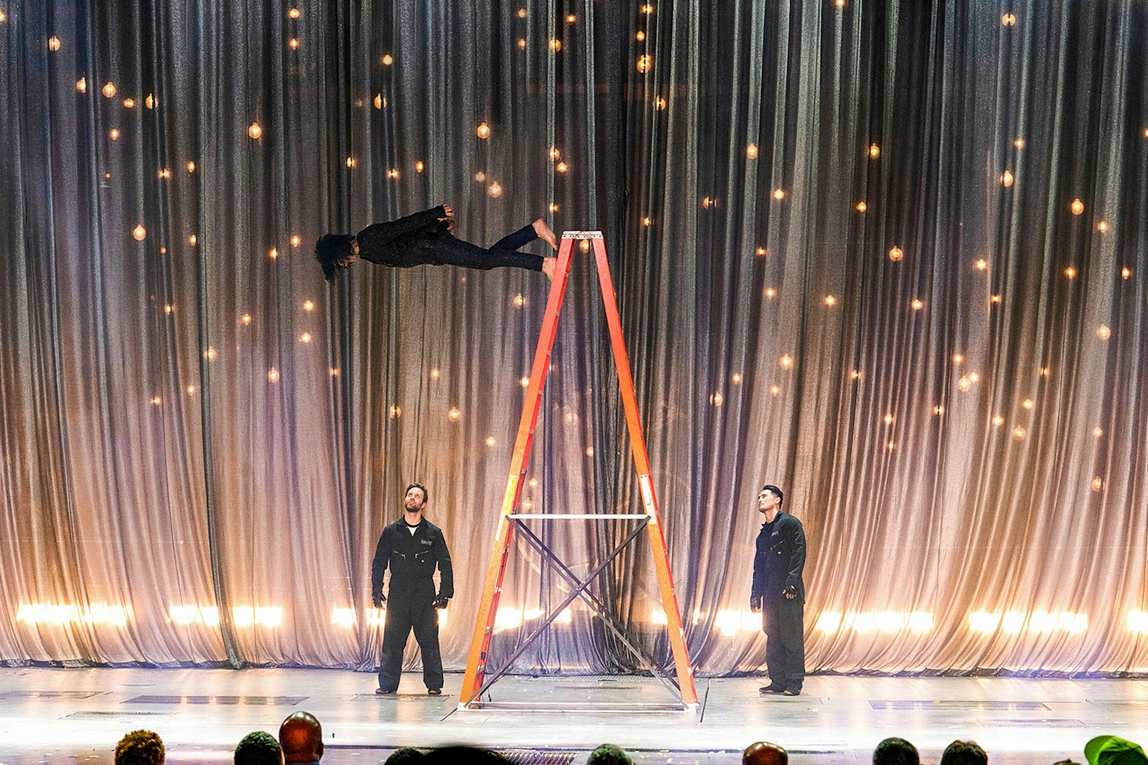 Illusionist performing levitation on stage during Criss Angel Mindfreak show.