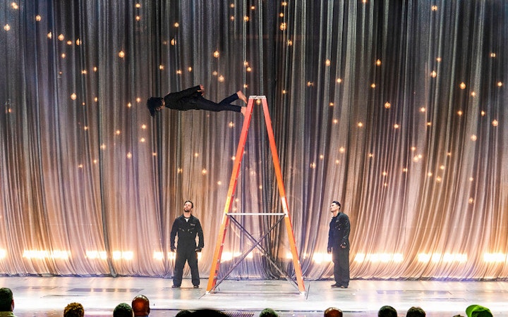 Illusionist performing levitation on stage during Criss Angel Mindfreak show.