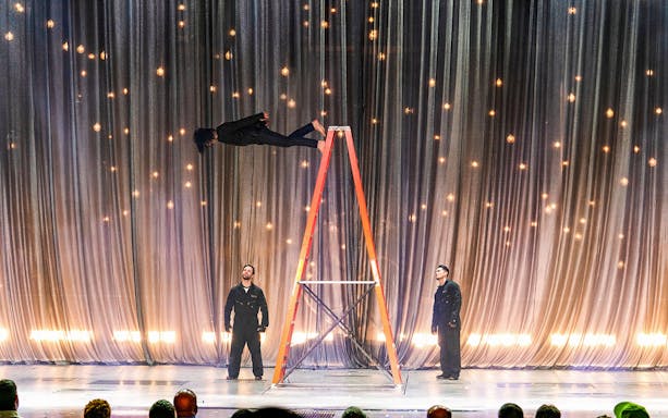 Illusionist performing levitation on stage during Criss Angel Mindfreak show.