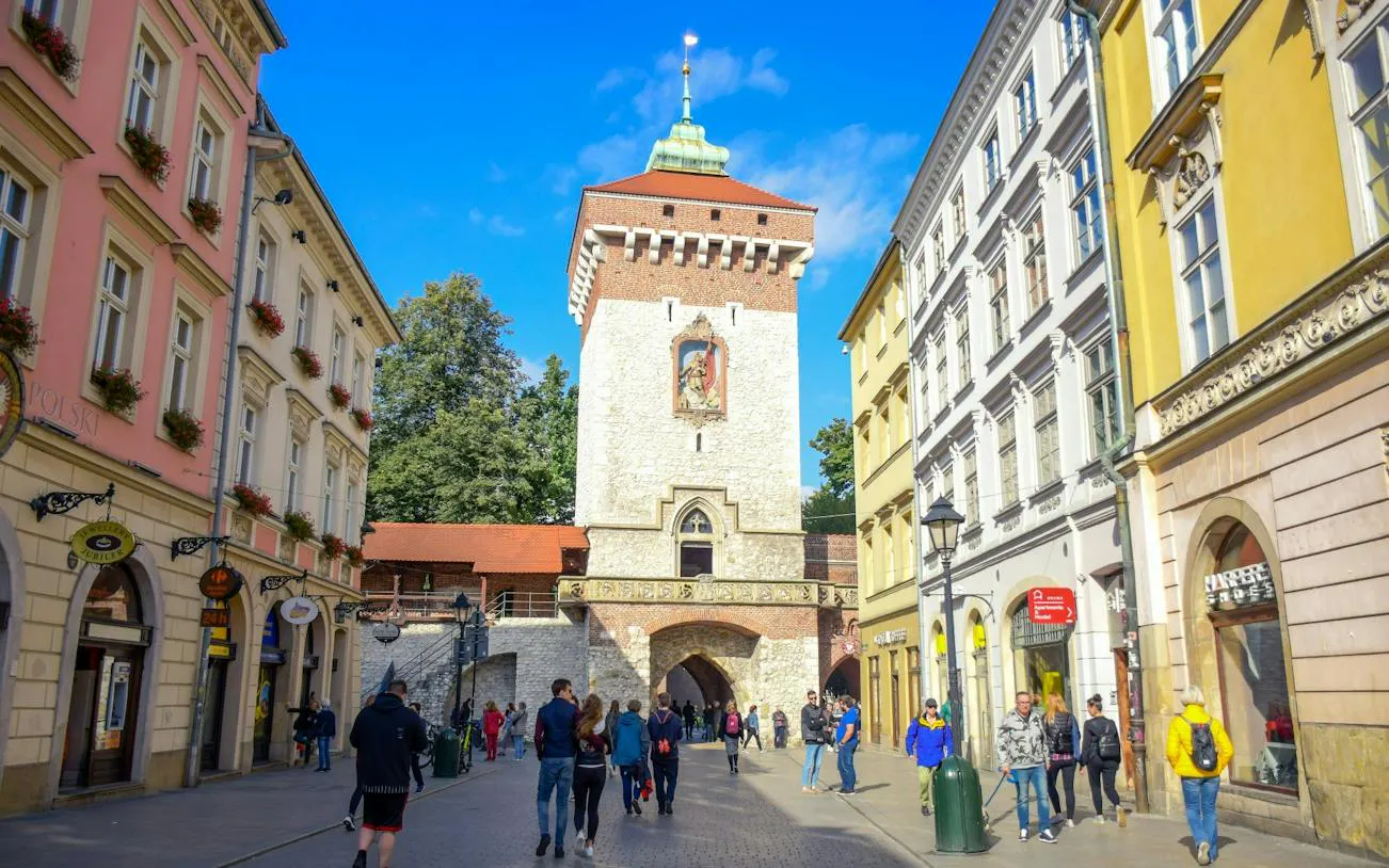 St. Florian's Gate in Krakow with people walking along the street.