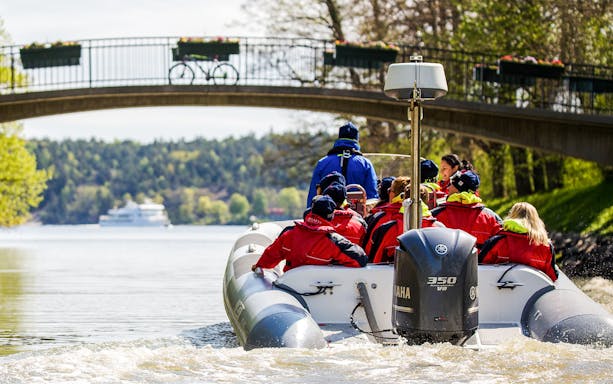 Passengers on Stockholm RIB speed boat cruising by Djurgården Well Canal, Stockholm.