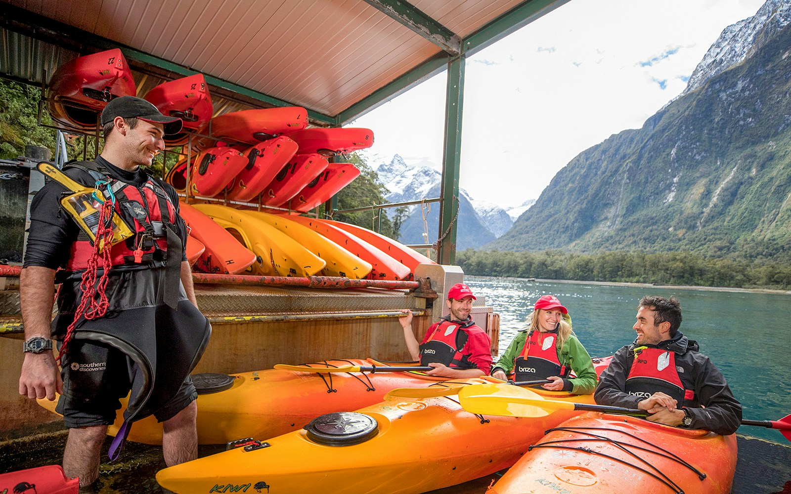 Kayak guide giving a safety briefing to people in kayaks in Milford Sounds