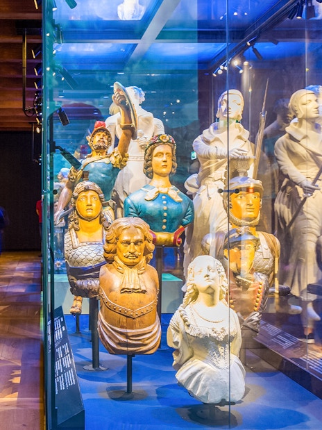 Figureheads and maritime artifacts on display at The Maritime Museum, Amsterdam.