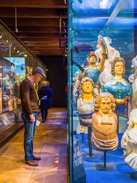 Figureheads and maritime artifacts on display at The Maritime Museum, Amsterdam.