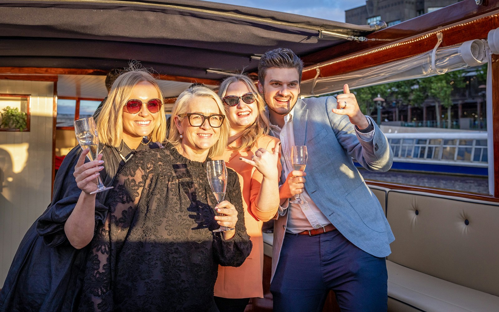 Passengers celebrating on a Yarra River sunset cruise in Melbourne.