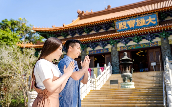 Visitors praying at Po Lin Monastery, Hong Kong.