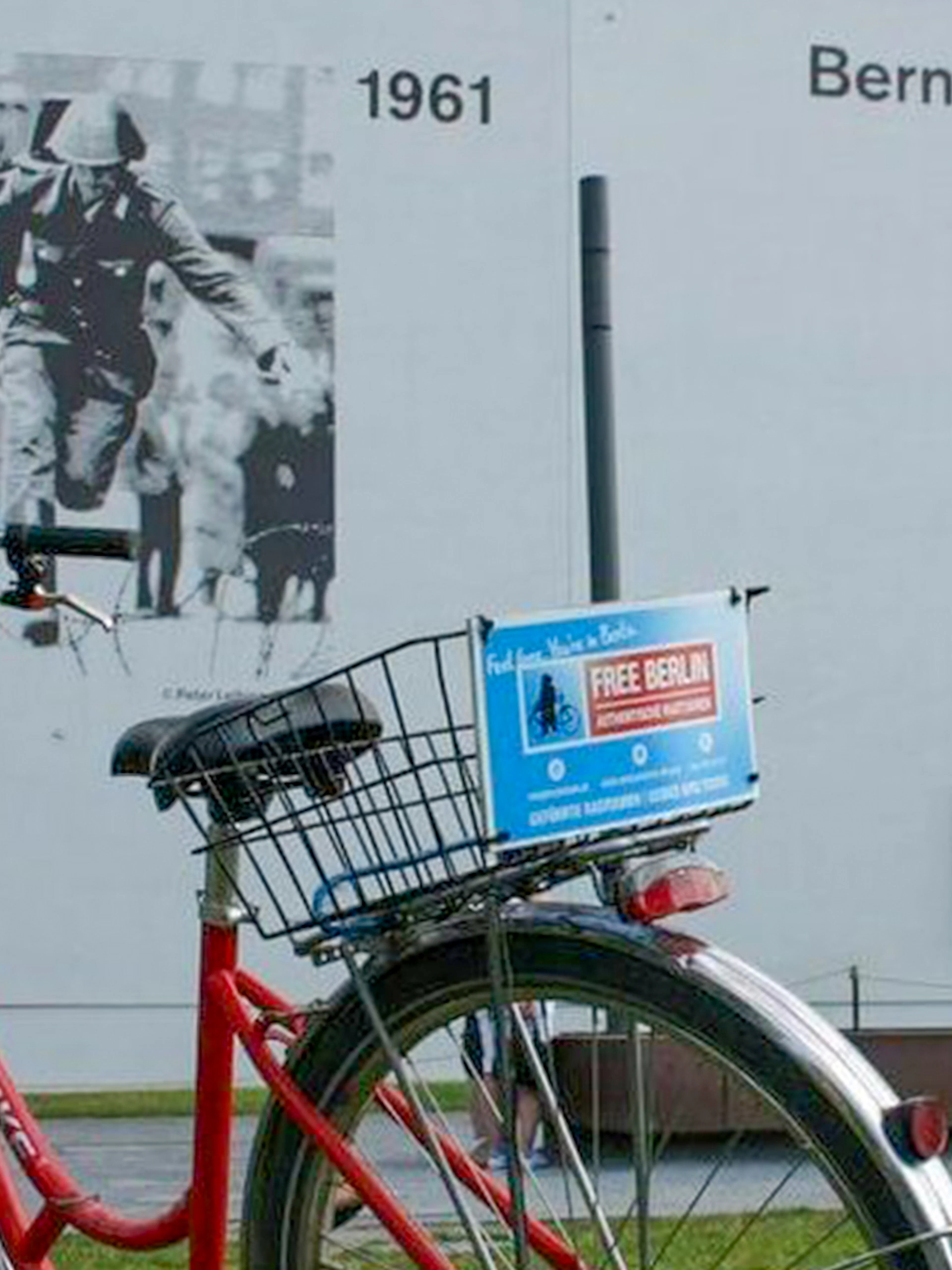 Red bike near Berlin Wall mural at Bernauer Straße, part of Guided Bike Tour: Third Reich & The Wall.