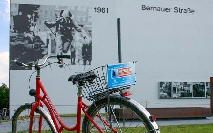Red bike near Berlin Wall mural at Bernauer Straße, part of Guided Bike Tour: Third Reich & The Wall.