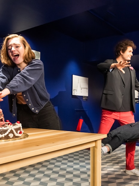 Visitors interacting with wax figures at Grévin Paris Wax Museum.