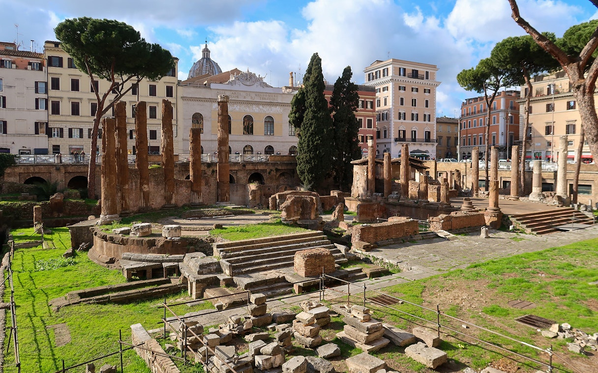 Ruins of ancient temples in Largo di Torre Argentina, Rome, with surrounding buildings.