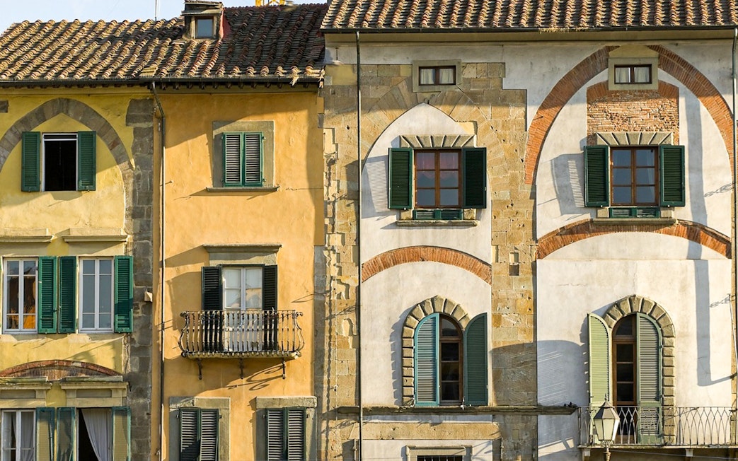 Colorful historic buildings in Pisa, Italy, seen on a guided walking tour.
