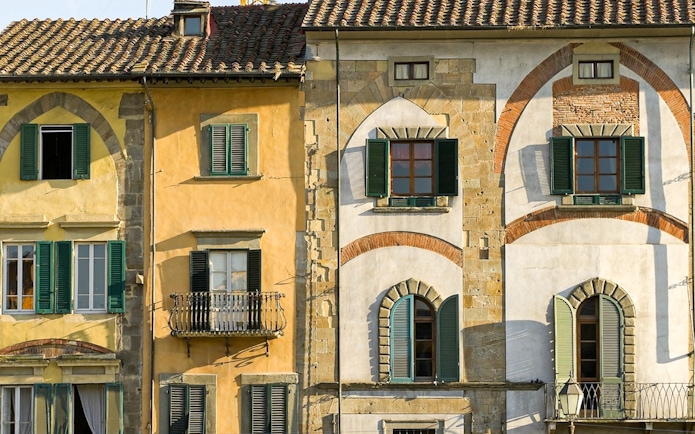 Colorful historic buildings in Pisa, Italy, seen on a guided walking tour.