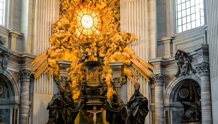 St. Peter's Chair in St. Peter's Basilica, Vatican City, surrounded by ornate architecture.