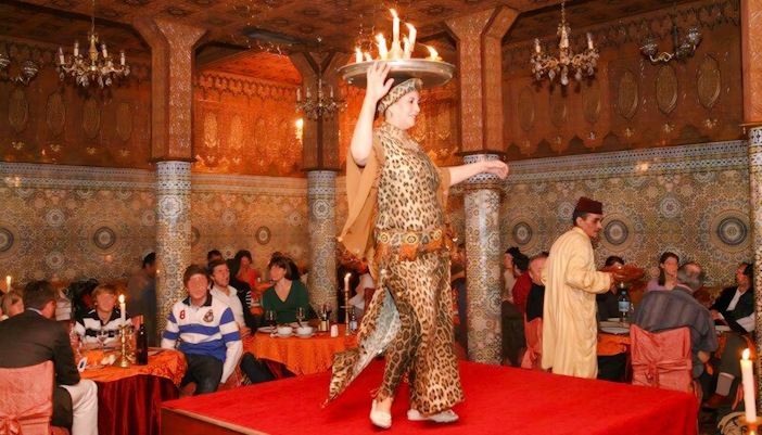 Performer balancing flaming tray at Dar Essalam Moroccan Dinner show.