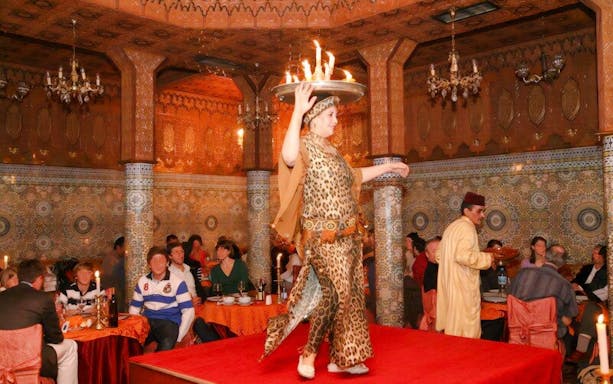 Performer balancing flaming tray at Dar Essalam Moroccan Dinner show.