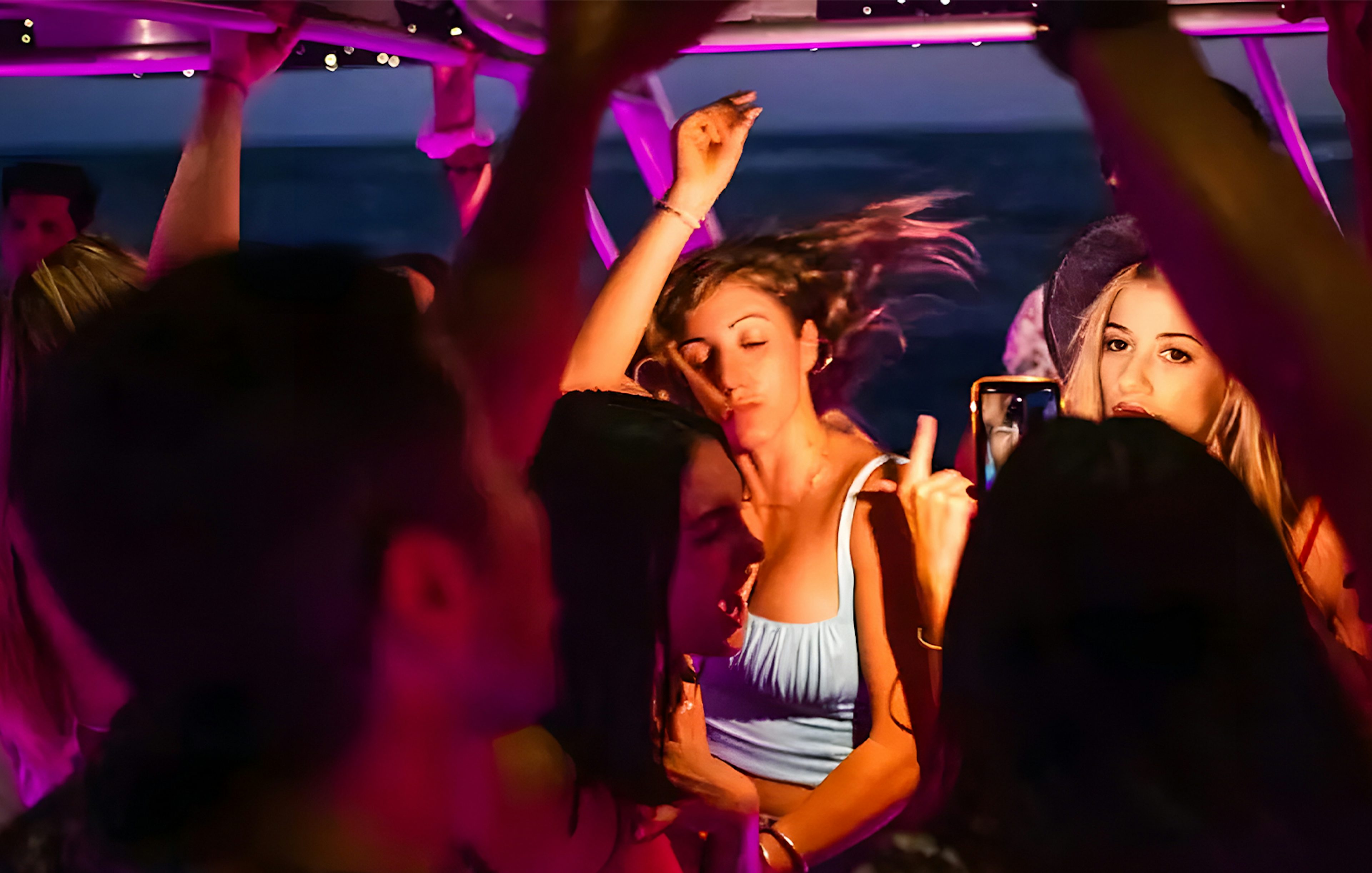 Girl dancing at a party on a Dubai Marina yacht.