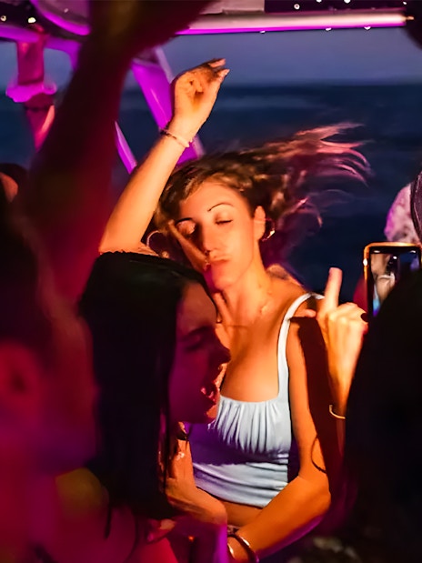 Girl dancing at a party on a Dubai Marina yacht.
