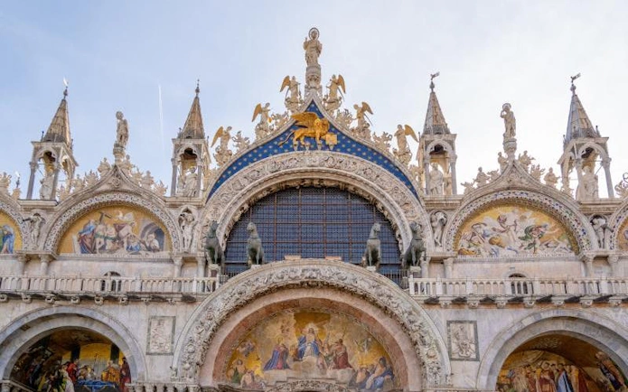 St. Mark’s Basilica ornate facade with detailed mosaics and sculptures in Venice, Italy.