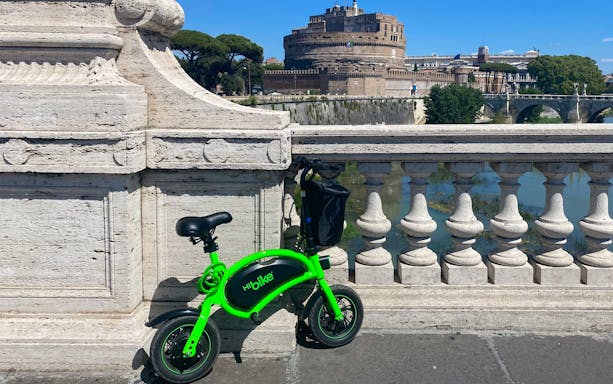 E-bike parked on a bridge with Castel Sant'Angelo in the background, Rome.