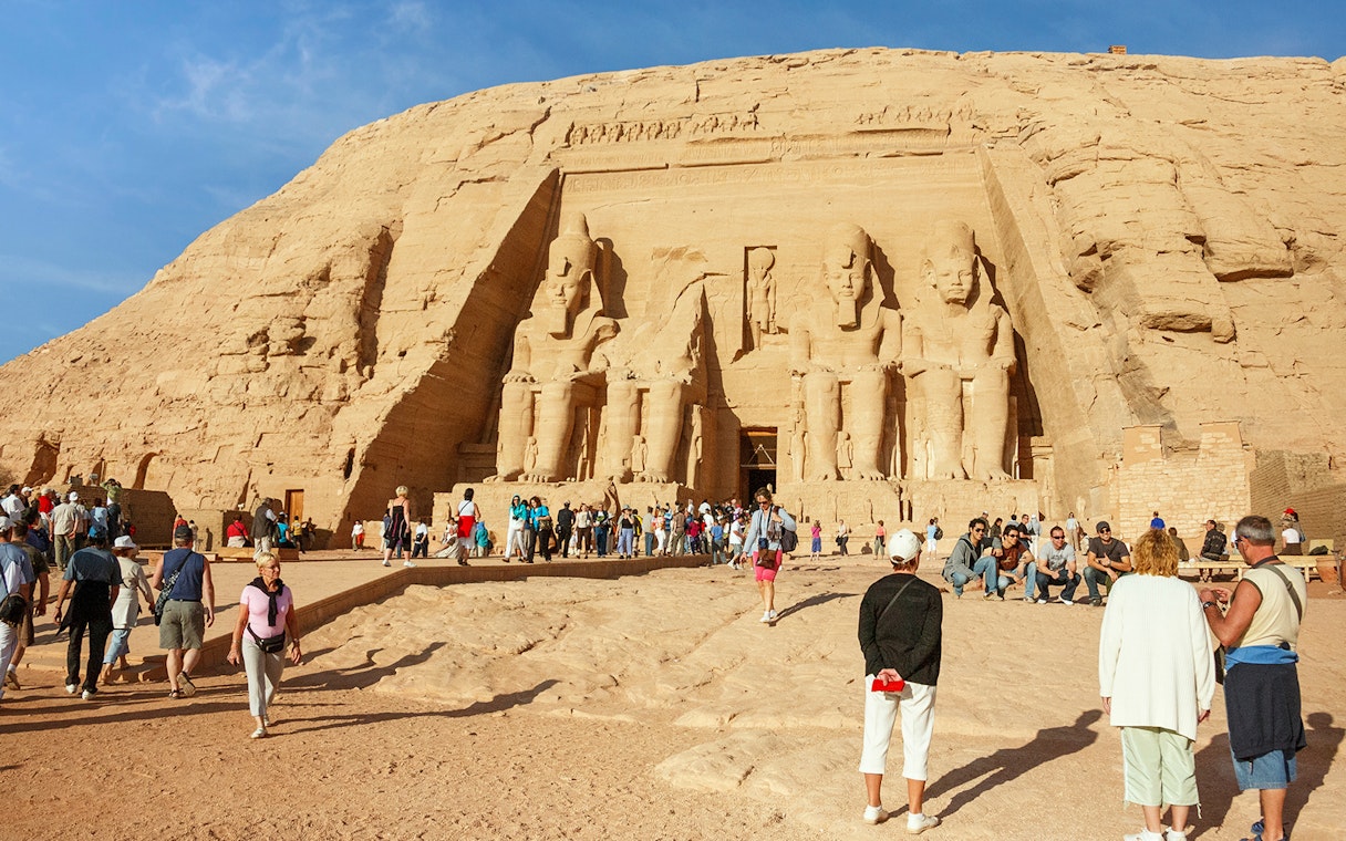 Abu Simbel temples with tourists exploring the site during a Nile cruise from Aswan to Luxor.