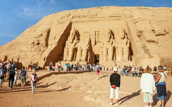 Abu Simbel temples with tourists exploring the site during a Nile cruise from Aswan to Luxor.