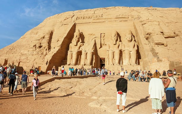 Abu Simbel temples with tourists exploring the site during a Nile cruise from Aswan to Luxor.