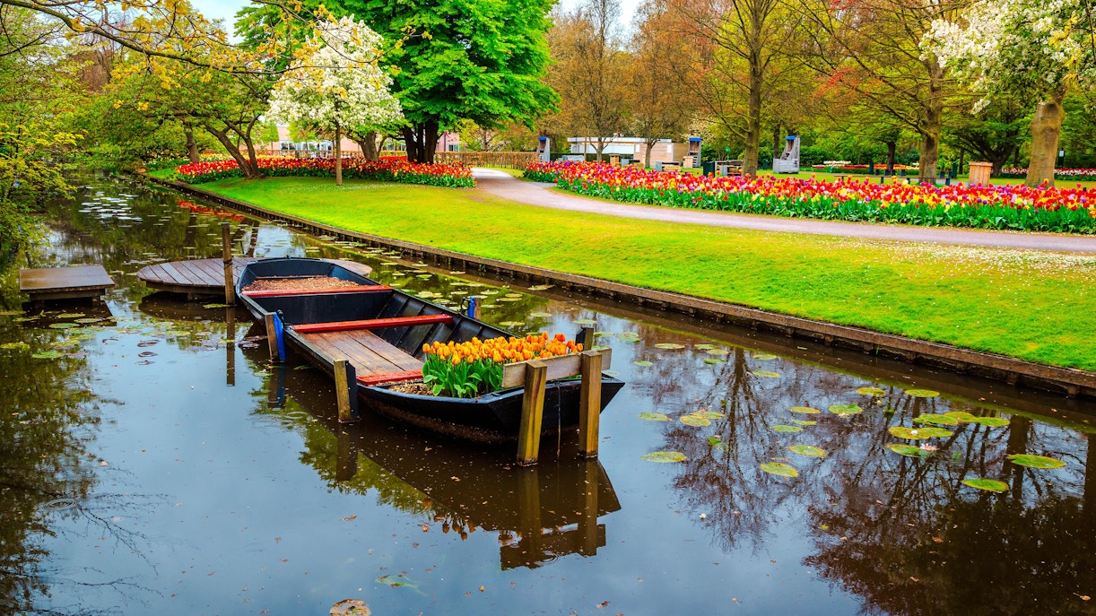 Whisper boat on canal surrounded by tulip gardens at Keukenhof.