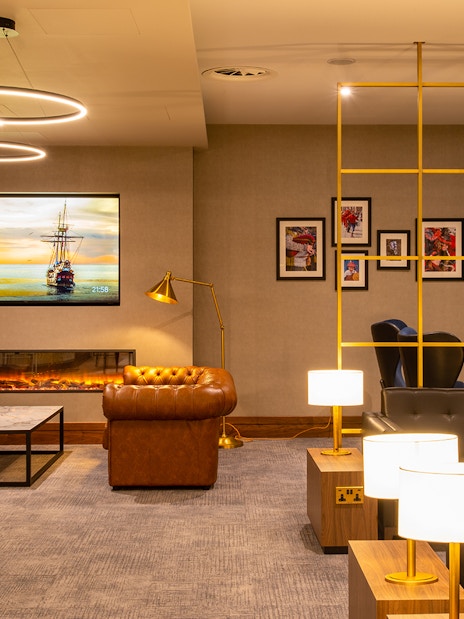 Plaza Premium Lounge seating area at Edinburgh Airport with modern decor and ambient lighting.