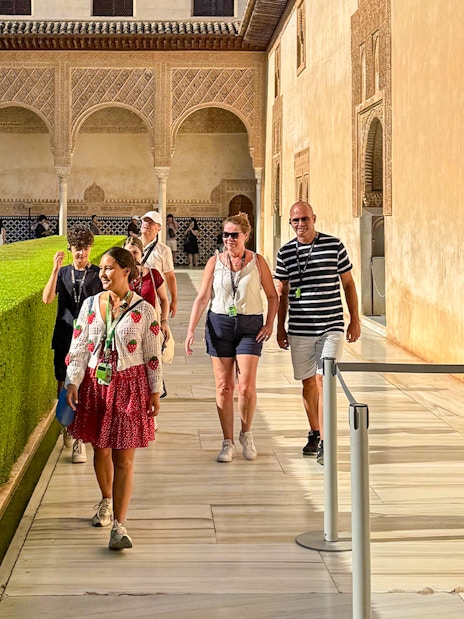 Tourists with guide walking at Alhambra, Granada, during guided tour without Nasrid Palaces.