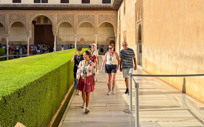 Tourists with guide walking at Alhambra, Granada, during guided tour without Nasrid Palaces.