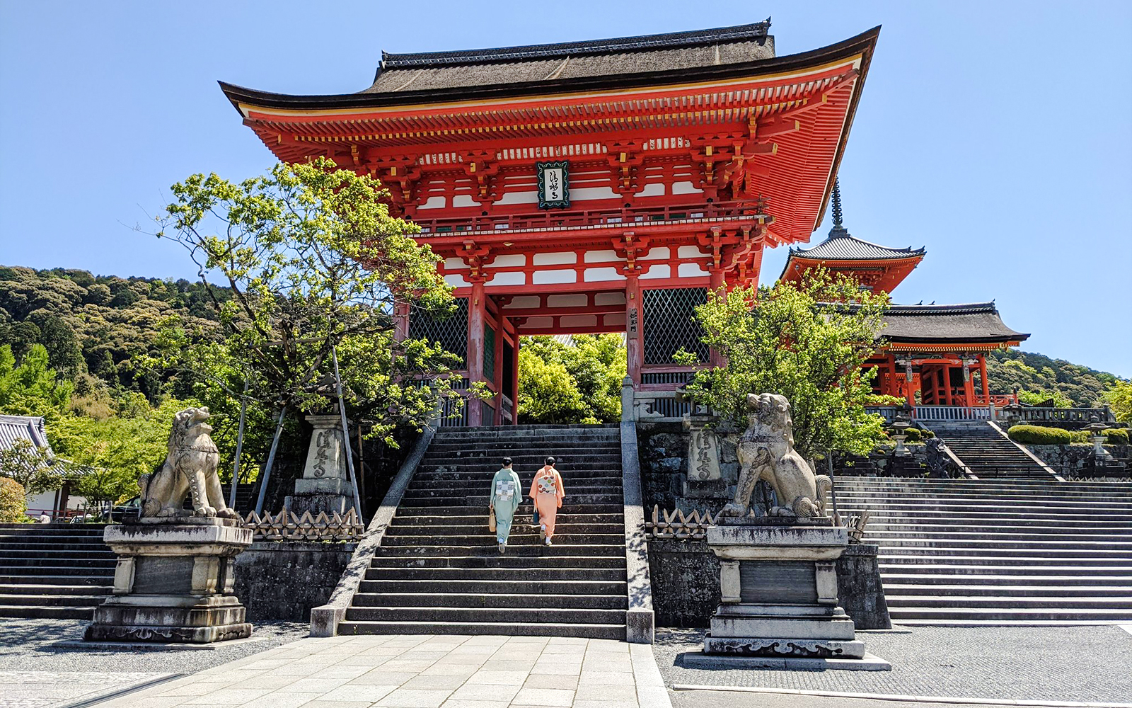 Two people in kimonos ascend steps at Kiyomizu-dera Temple, Kyoto.
