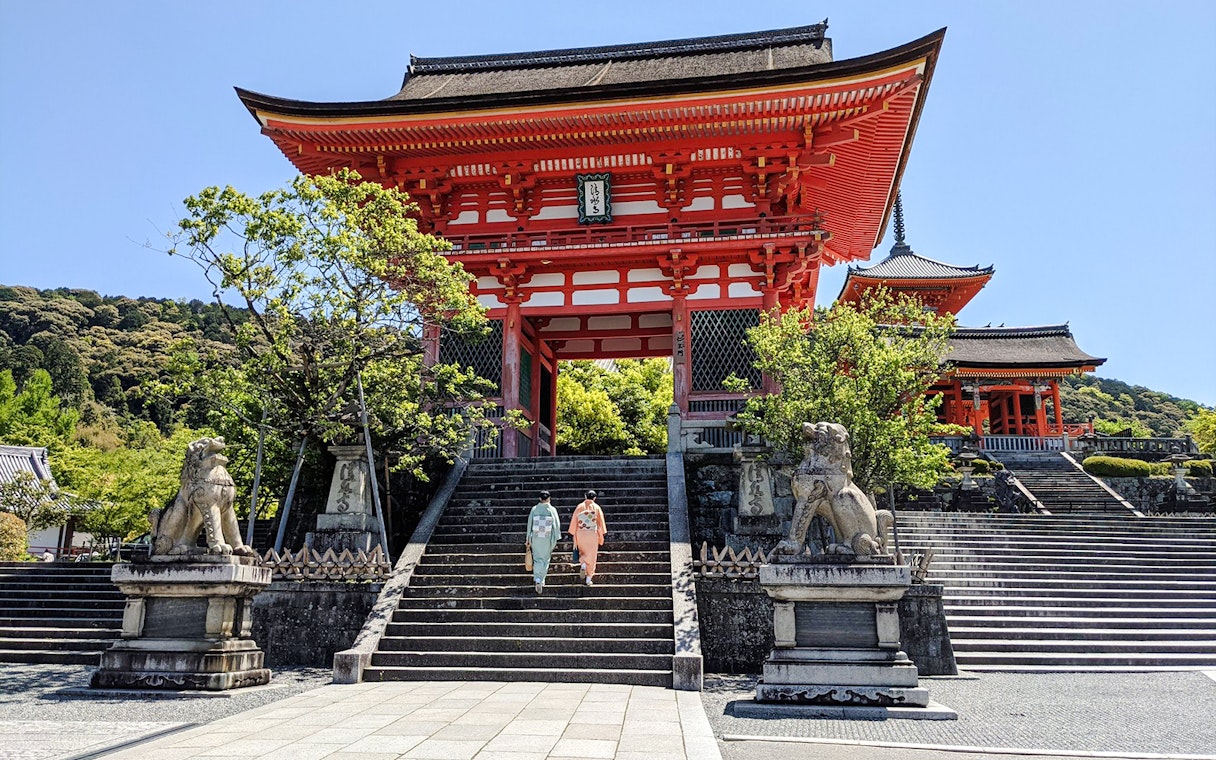 Two people in kimonos ascend steps at Kiyomizu-dera Temple, Kyoto.