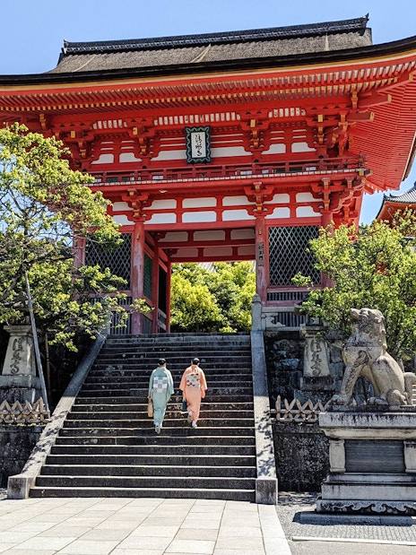 Two people in kimonos ascend steps at Kiyomizu-dera Temple, Kyoto.